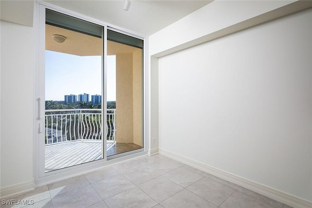 tiled spare room with floor to ceiling windows