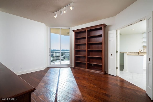 unfurnished room with dark wood-type flooring and expansive windows