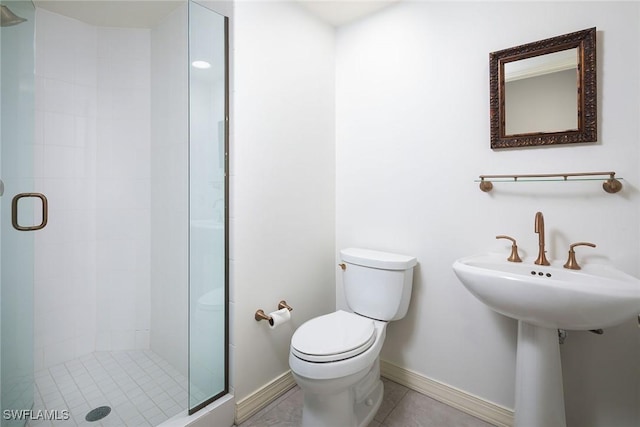 bathroom with toilet, tile patterned flooring, and an enclosed shower