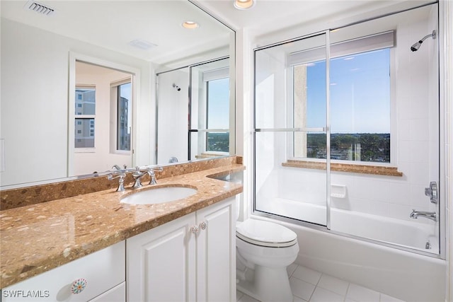 full bathroom with combined bath / shower with glass door, vanity, tile patterned floors, and a wealth of natural light