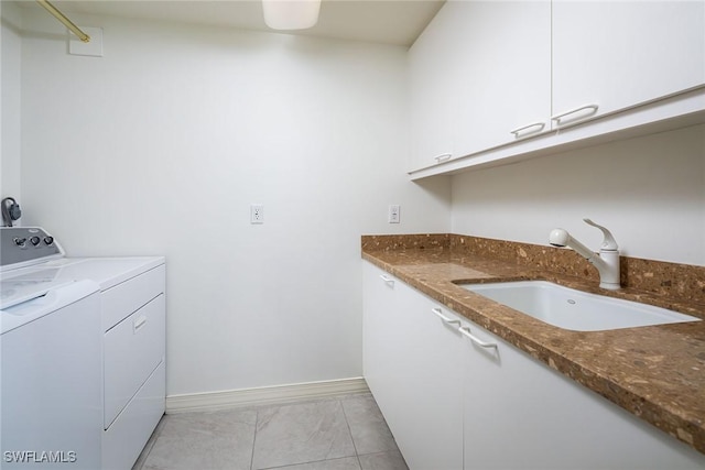 washroom with cabinets, sink, and independent washer and dryer