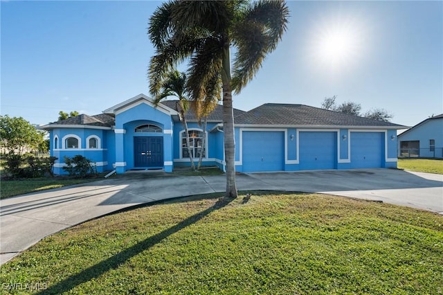 ranch-style home featuring a garage and a front lawn