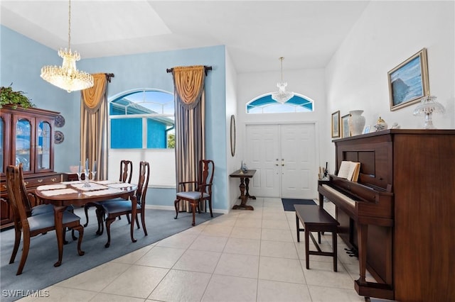 foyer featuring a notable chandelier, light tile patterned floors, and a high ceiling