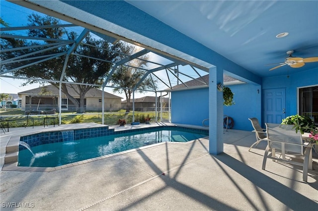 view of swimming pool with pool water feature, ceiling fan, a lanai, and a patio area