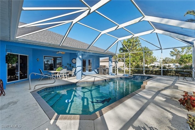 view of swimming pool featuring a patio, a lanai, french doors, and ceiling fan