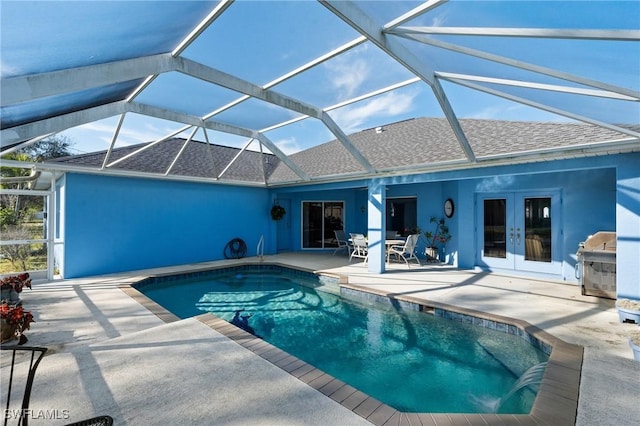 view of pool featuring a patio, french doors, a grill, and glass enclosure