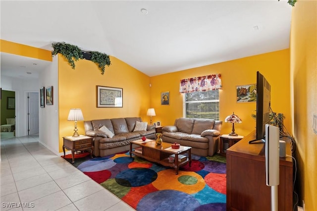 living room with vaulted ceiling and light tile patterned floors