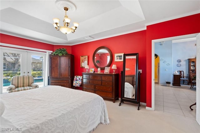 carpeted bedroom featuring french doors, a tray ceiling, a chandelier, and access to outside