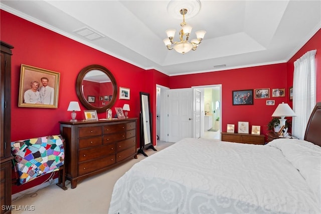 bedroom with light colored carpet, a notable chandelier, ensuite bath, and a tray ceiling