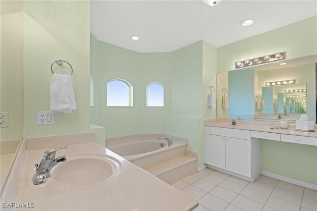 bathroom with tile patterned floors, vanity, and a bathing tub