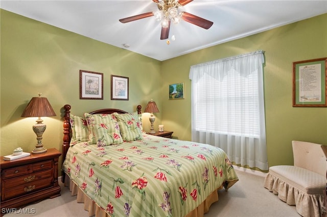 bedroom with light colored carpet and ceiling fan