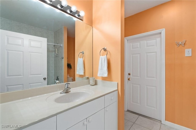 bathroom featuring vanity, a tile shower, and tile patterned floors