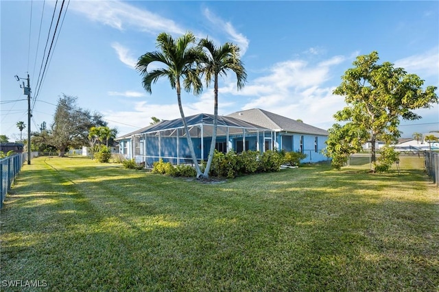 back of property featuring a lawn and glass enclosure