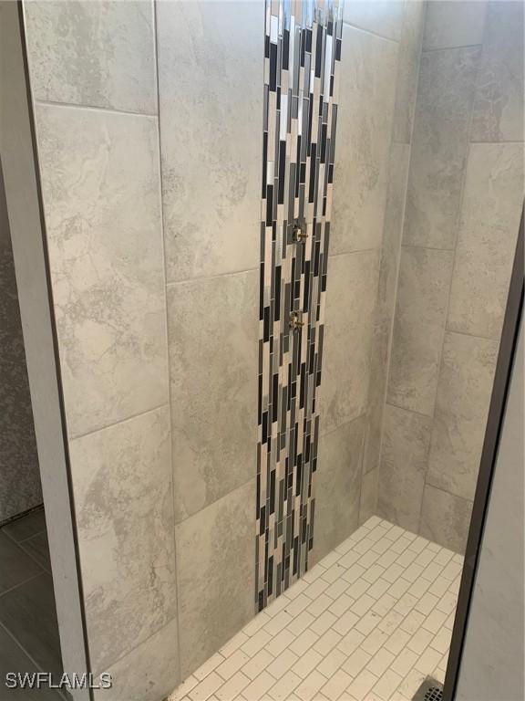 bathroom with a tile shower