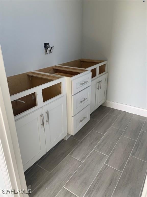 bathroom with baseboards and wood tiled floor