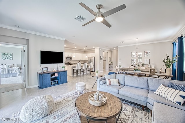 tiled living room featuring ceiling fan and ornamental molding