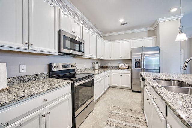 kitchen featuring white cabinets, stainless steel appliances, sink, hanging light fixtures, and crown molding