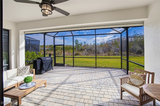 sunroom / solarium featuring ceiling fan