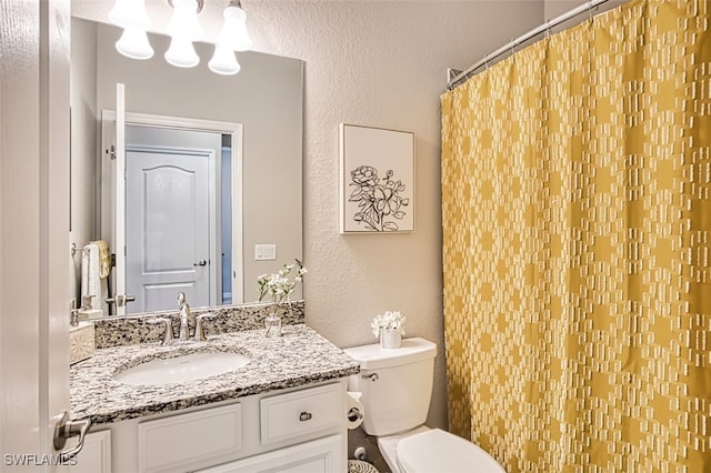 bathroom with toilet and vanity