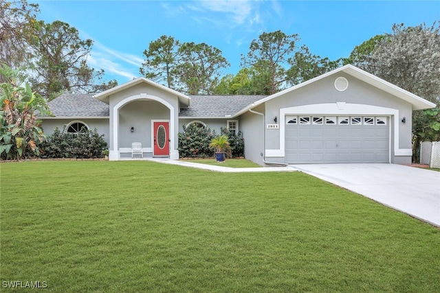 ranch-style house featuring a front lawn and a garage