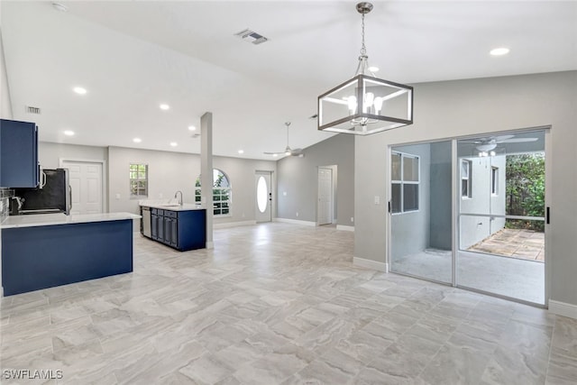 kitchen with sink, pendant lighting, blue cabinetry, and ceiling fan with notable chandelier