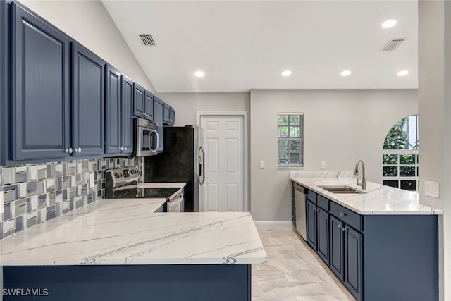 kitchen featuring sink, blue cabinets, light stone counters, and appliances with stainless steel finishes