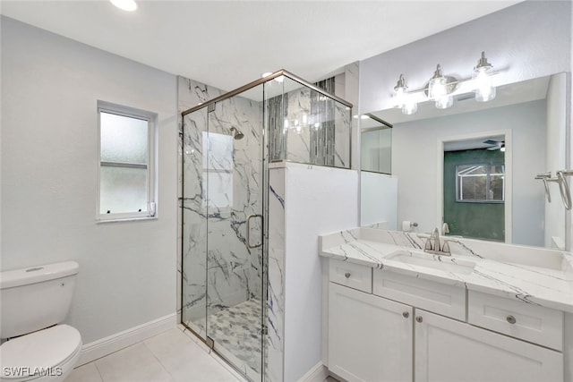 bathroom with toilet, tile patterned flooring, a shower with shower door, and vanity