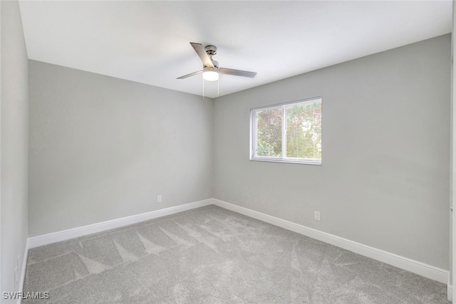 spare room with light colored carpet and ceiling fan