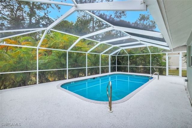 view of pool featuring a patio and glass enclosure