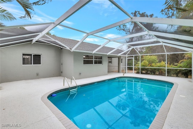 view of swimming pool with a lanai and a patio