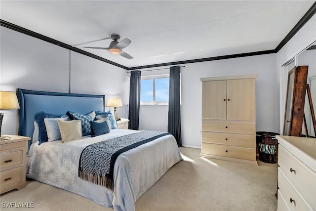 carpeted bedroom featuring a closet, ceiling fan, and crown molding