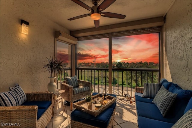 sunroom / solarium featuring ceiling fan and a wealth of natural light