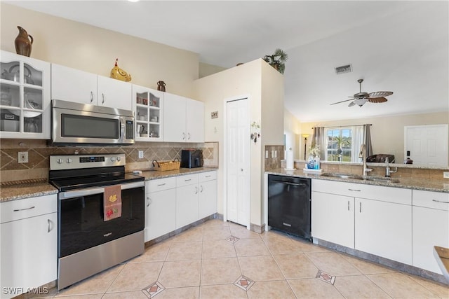 kitchen with ceiling fan, sink, decorative backsplash, white cabinets, and appliances with stainless steel finishes