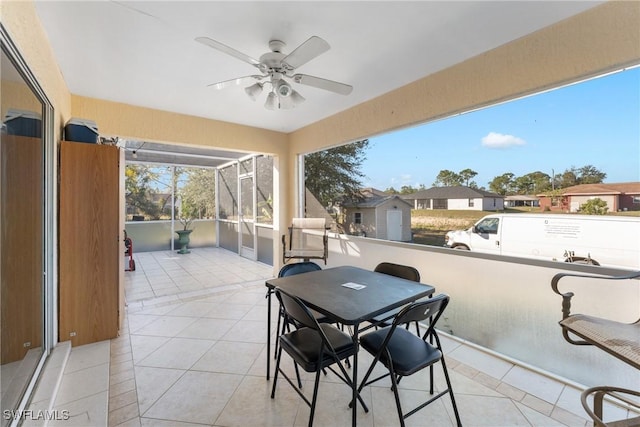 view of patio featuring glass enclosure and ceiling fan