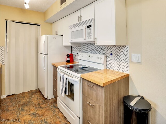 kitchen featuring white cabinetry, backsplash, white appliances, and wooden counters