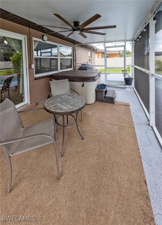 sunroom / solarium featuring a wealth of natural light and ceiling fan