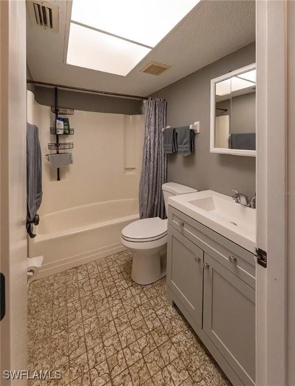 full bathroom featuring shower / tub combo, vanity, and toilet