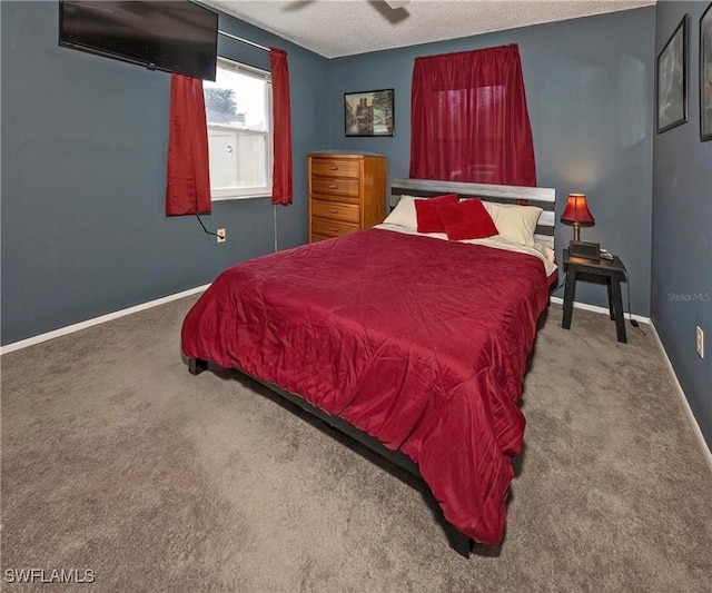 carpeted bedroom featuring a textured ceiling and ceiling fan