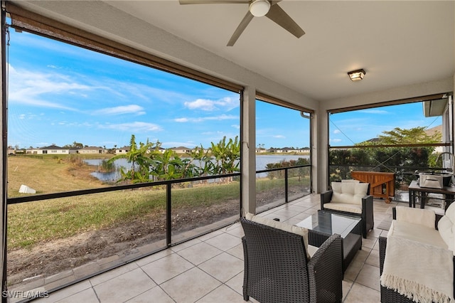 interior space featuring a water view, ceiling fan, and an outdoor hangout area