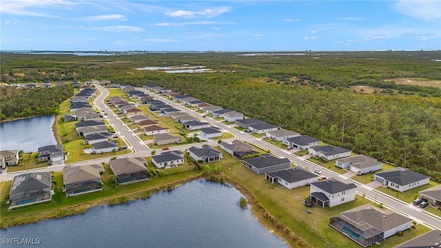 drone / aerial view with a residential view and a water view