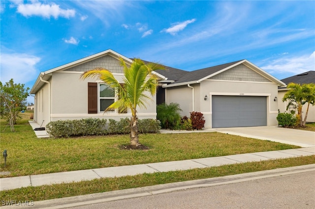 ranch-style house featuring an attached garage, driveway, a front yard, and stucco siding