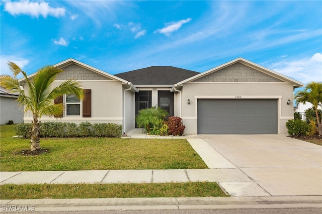 single story home featuring a garage and a front lawn