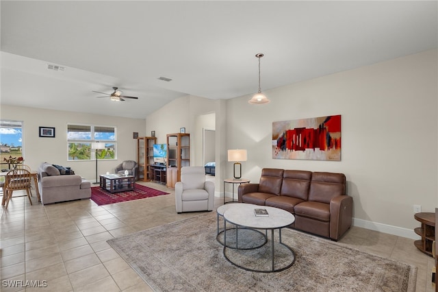 living area featuring lofted ceiling, visible vents, and light tile patterned flooring