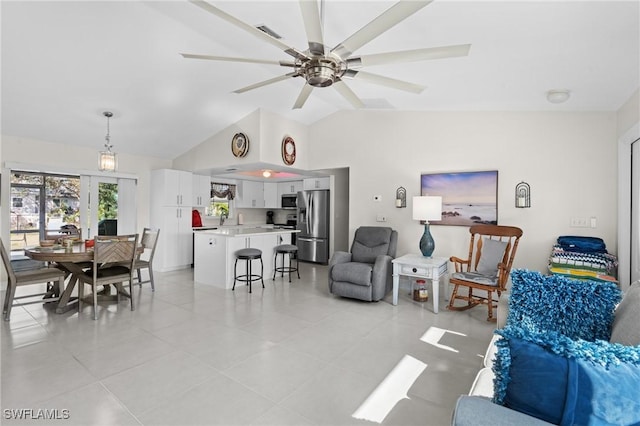 tiled living room featuring ceiling fan and lofted ceiling