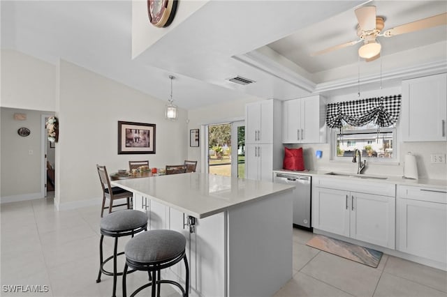 kitchen featuring white cabinetry, sink, a kitchen island, and stainless steel dishwasher