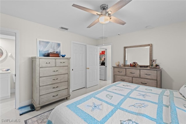 tiled bedroom featuring ceiling fan and ensuite bath