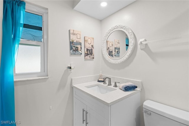 bathroom featuring vanity and toilet