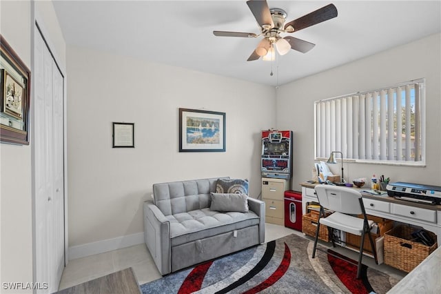 tiled office space featuring ceiling fan