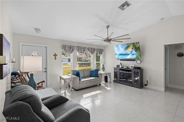 living room featuring ceiling fan, light tile patterned flooring, and lofted ceiling