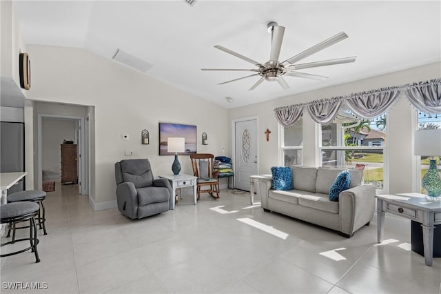 tiled living room with ceiling fan and lofted ceiling